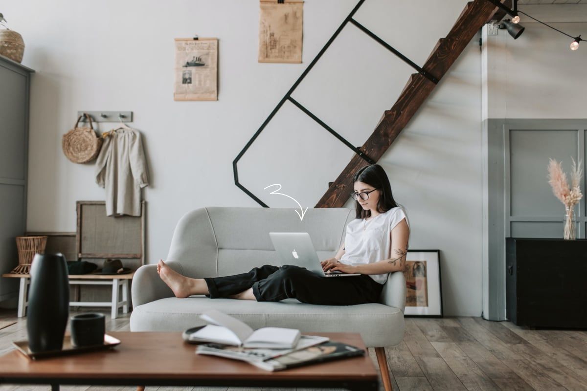 Woman with Macbook on couch