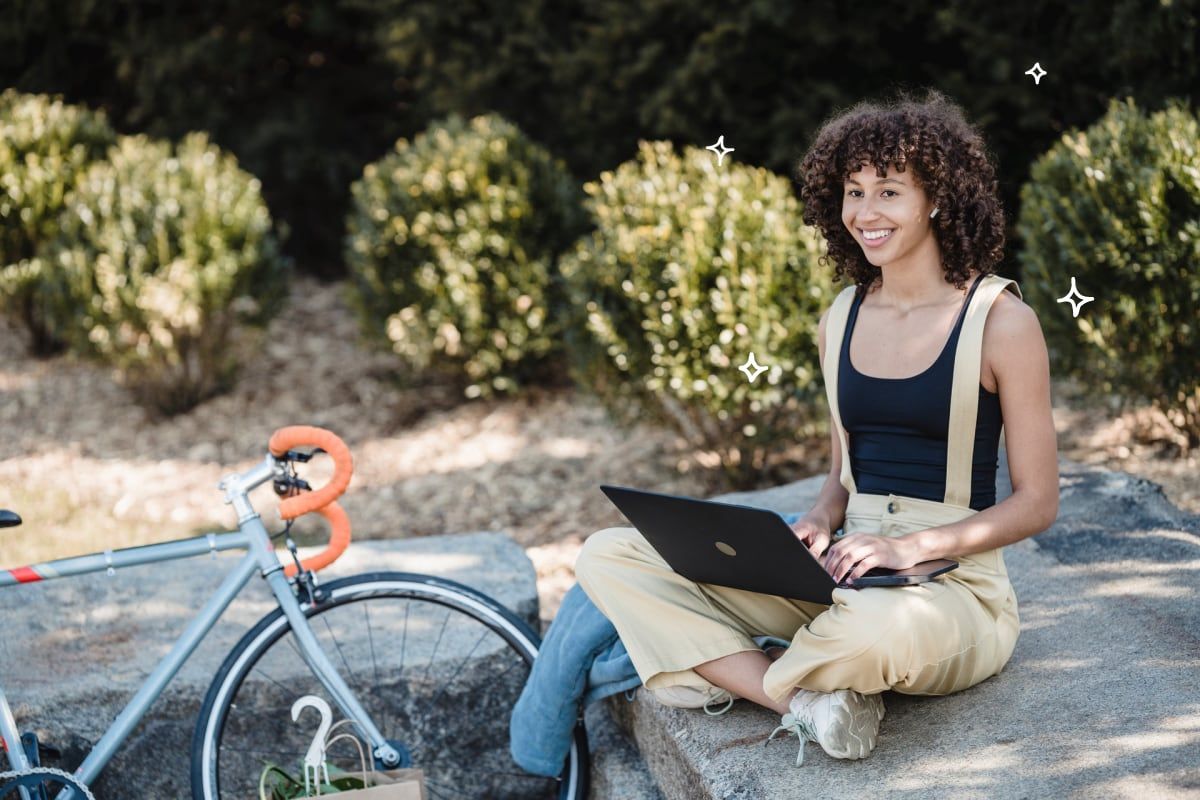 Woman on computer with bicycle