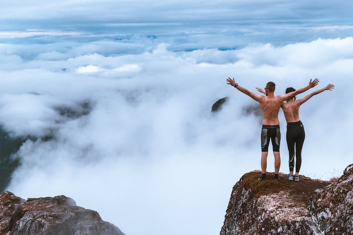 Couple climbing mountain