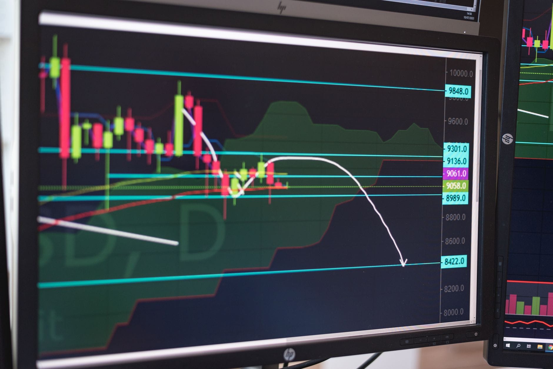 Trader examining Bitcoin halving cycle data on multiple screens with historical price charts