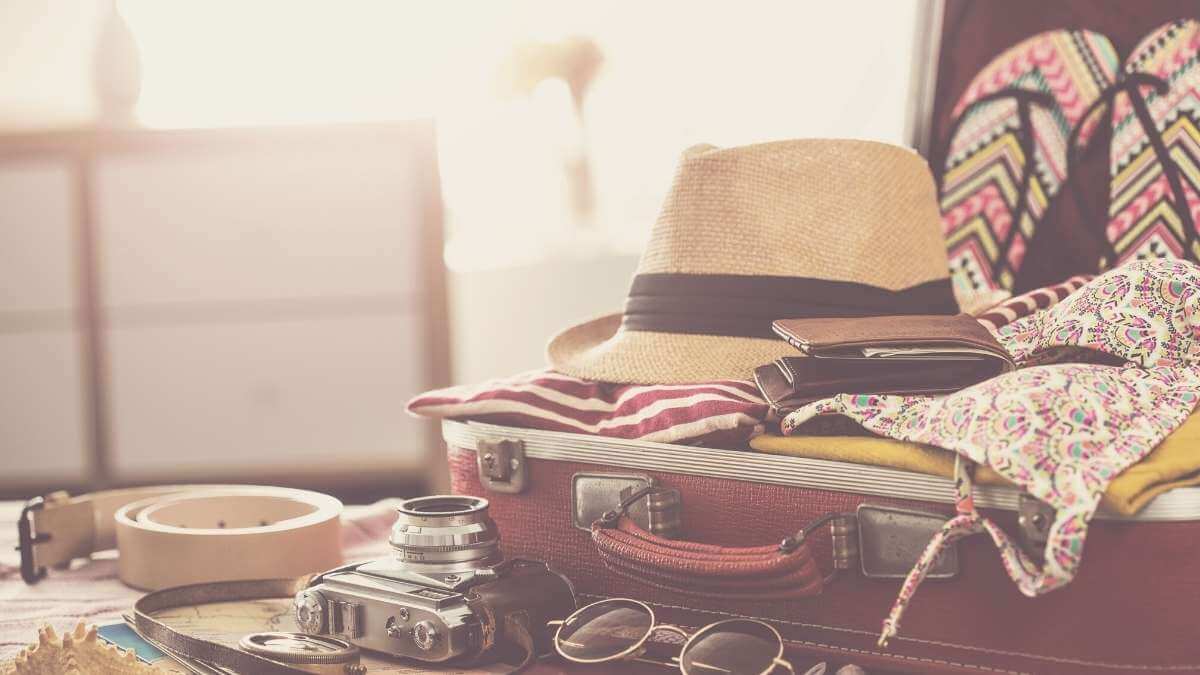 A female escort's untidy suitcase, packed for a sex work tour.