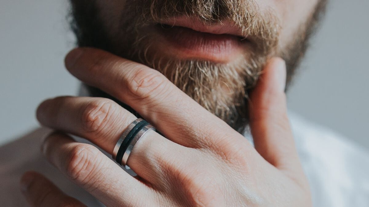 A close up of a male sex work client's face and beard.