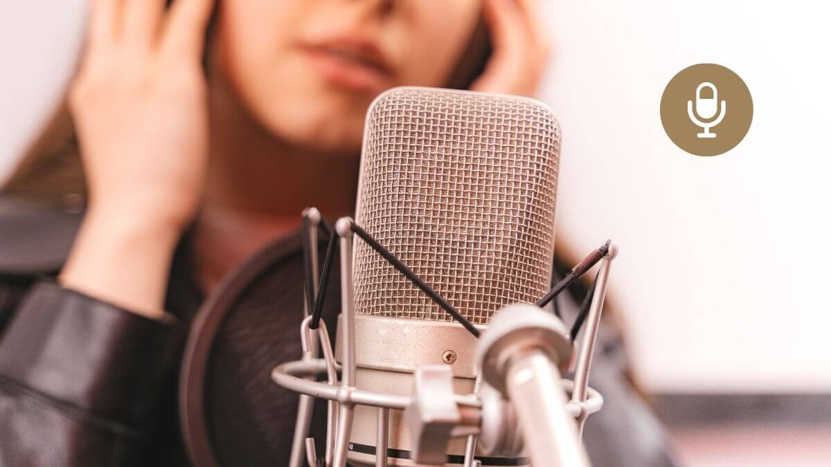 A female escort speaks into a podcast recording microphone.