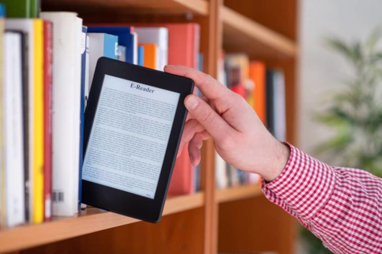 digital products - bookshelp with man's hands pulling out an e-reader