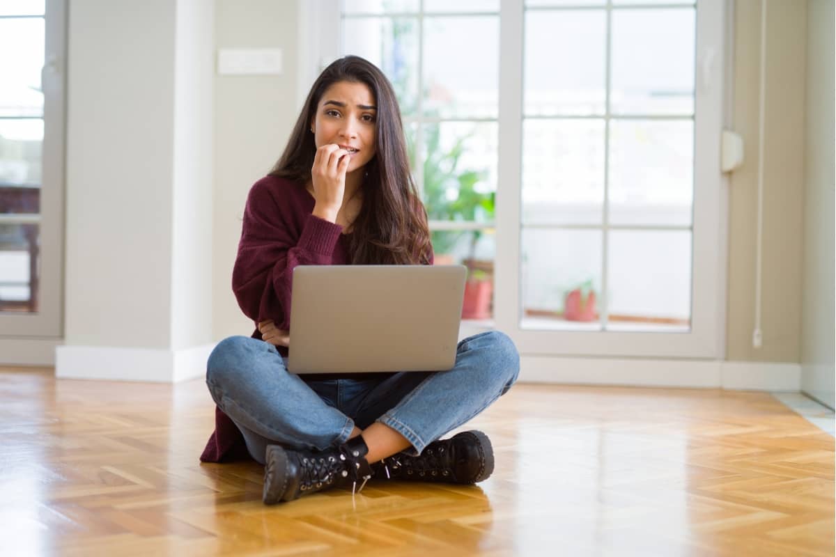 social media engagement - woman with a scared look holding a laptop