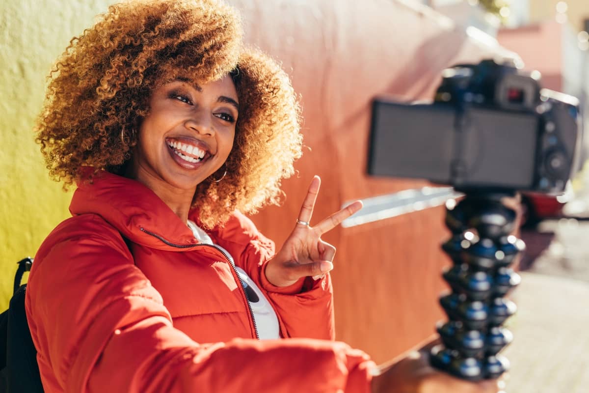 social media engagement - woman taking a selfie flashing the "peace" sign