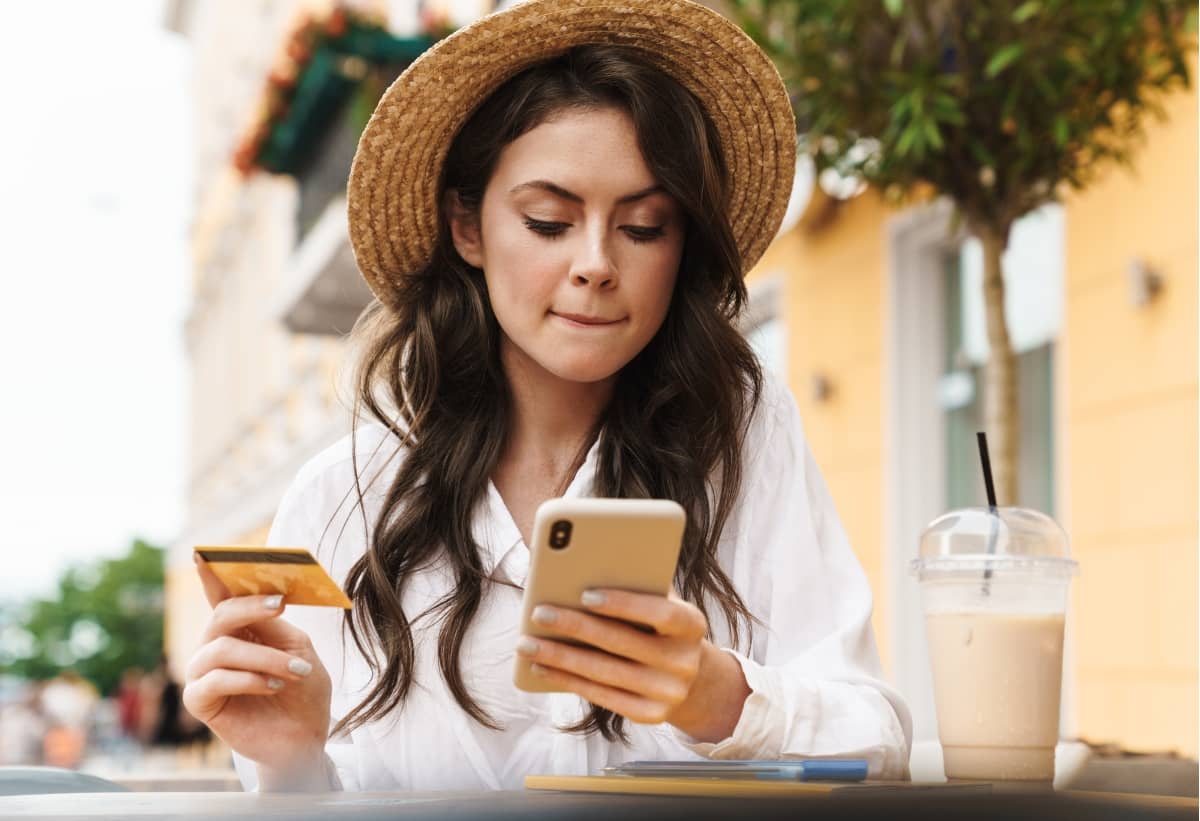 digital marketing - woman with mobile phone and credit card