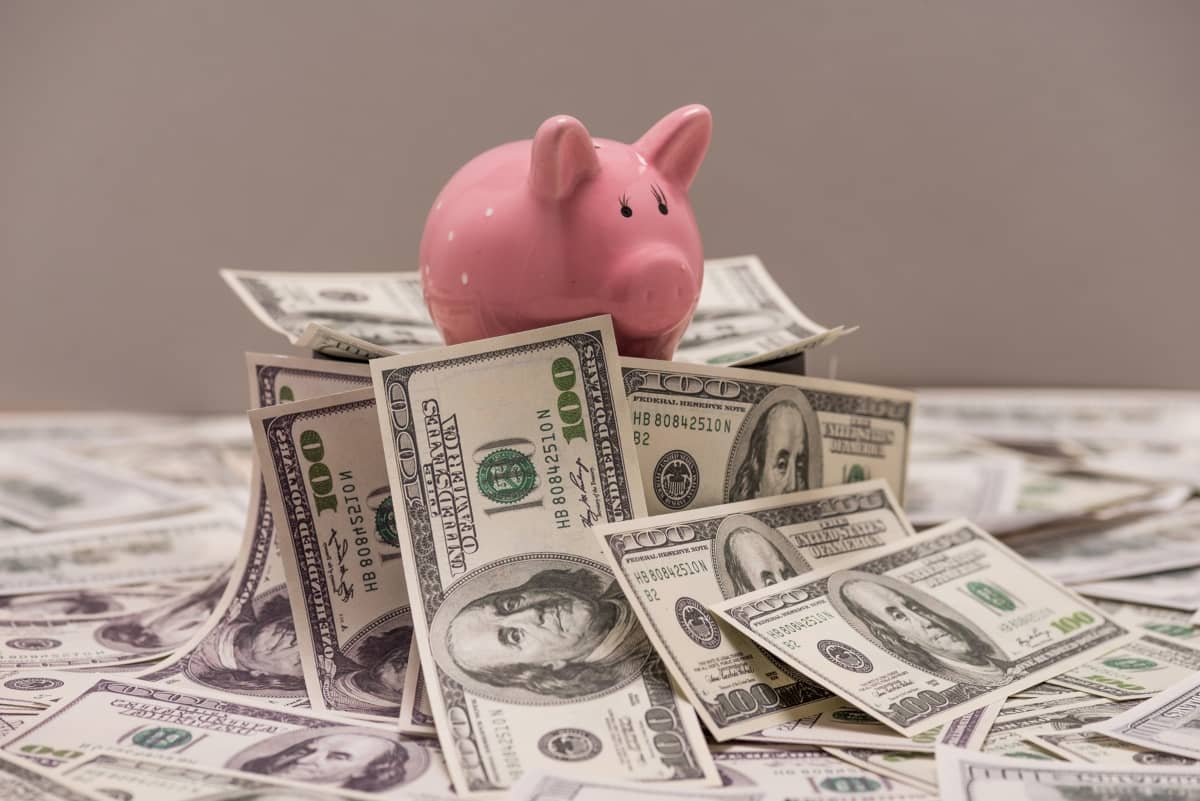 content marketing - piggy bank on top of $100 bills