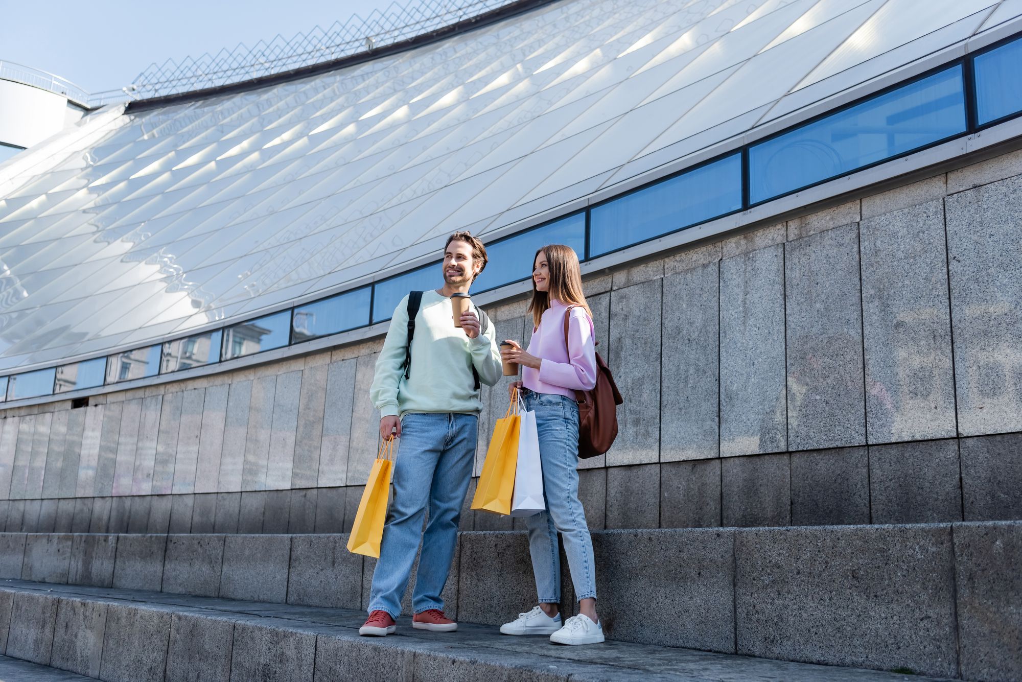 email marketing funnel - man and woman drinking coffee with shopping bags