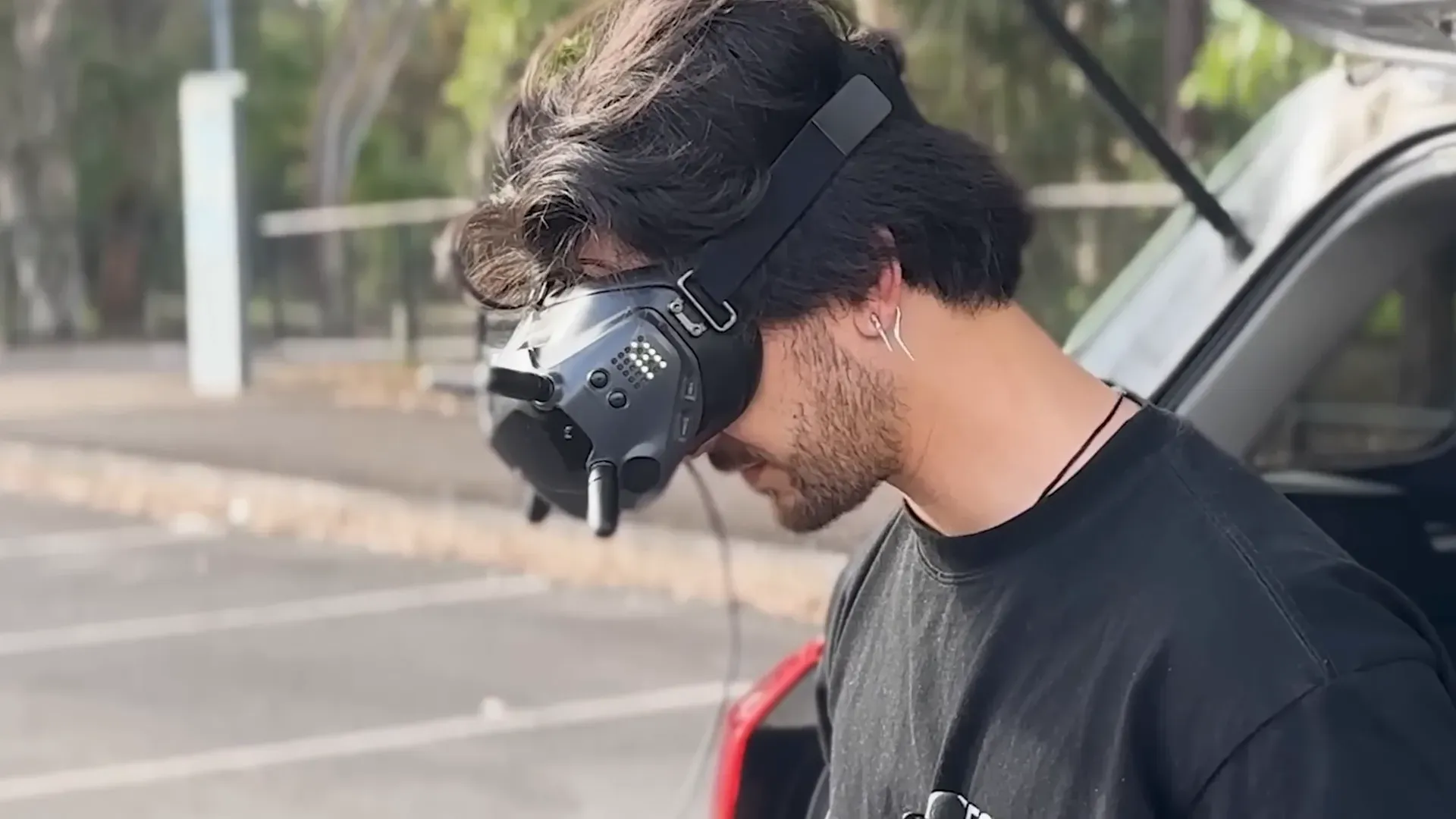 NickFPV reflecting on trade-offs while holding goggles