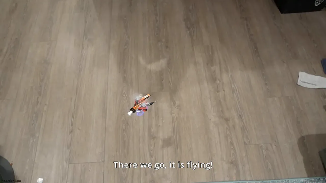 Tiny drone hovering above hand on first test flight