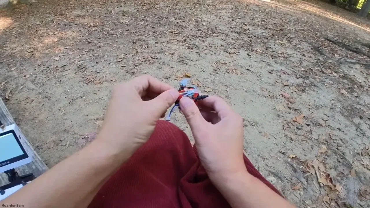 Drone mid-flight comparing battery sizes