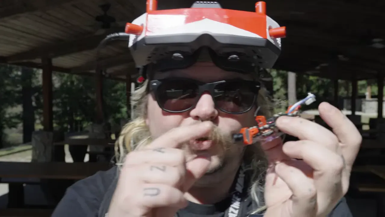 Both tiny drones on a table, analog and 04 Air Unit versions side-by-side