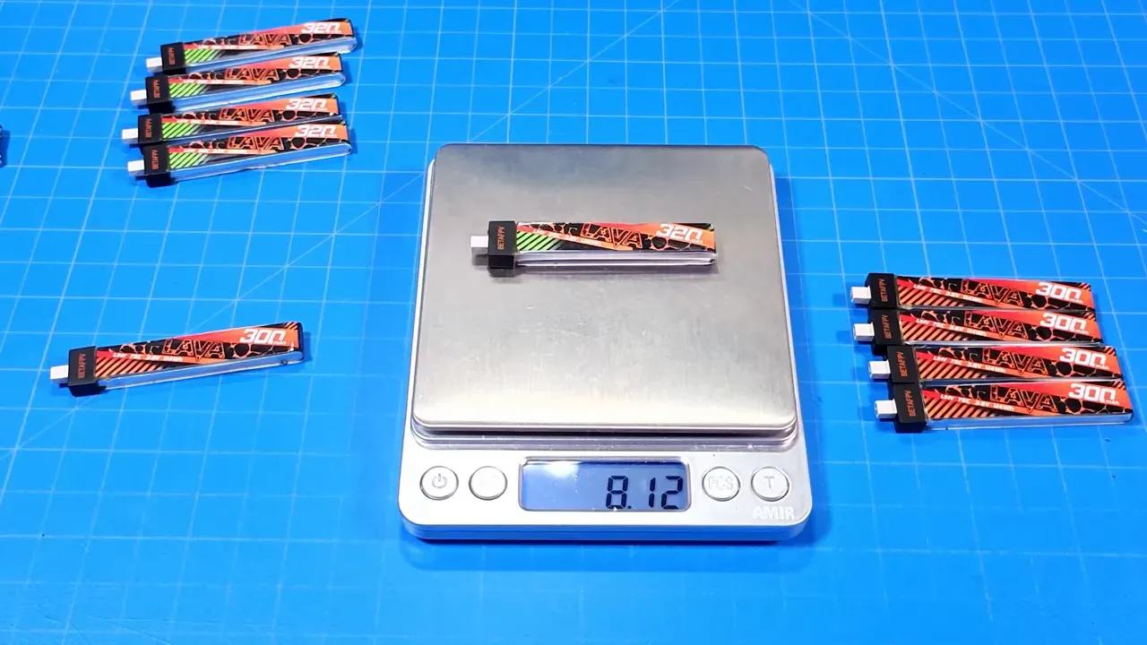 Digital scale showing a single Lava battery pack with a readout of 8.12 grams and additional packs on the mat