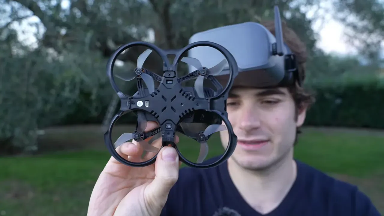 Aquila20 ducted whoop drone held up to camera showing underside and propellers