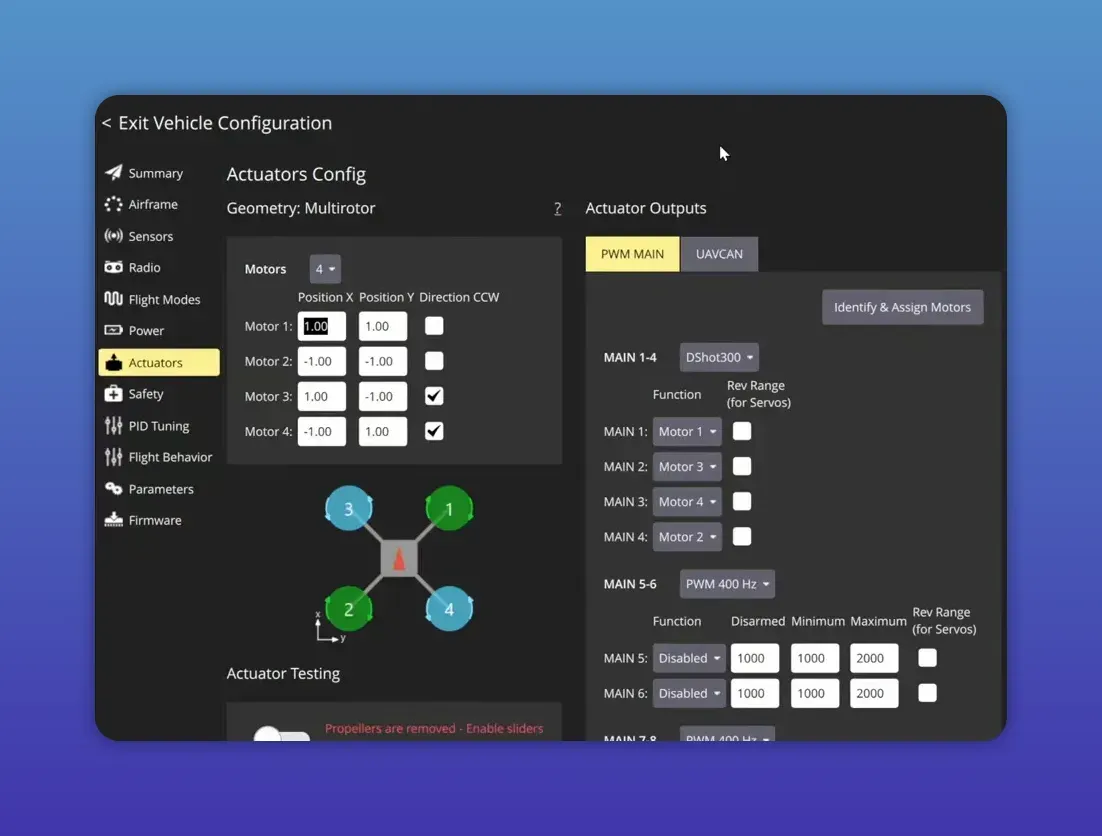 QGroundControl Actuators Config showing motor X and Y position fields and a presenter’s hands adjusting the quadcopter frame