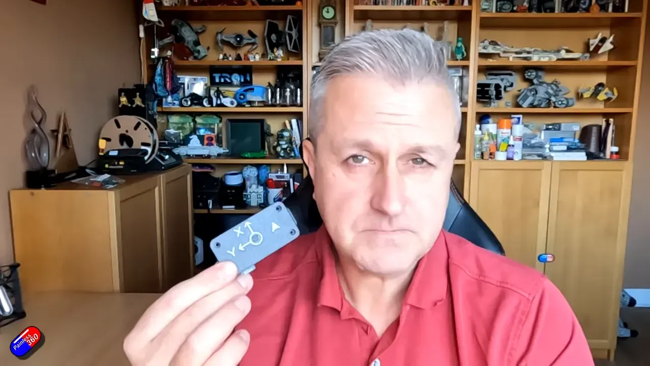 Hand holding Landmark precision-landing unit with X/Y orientation markings visible