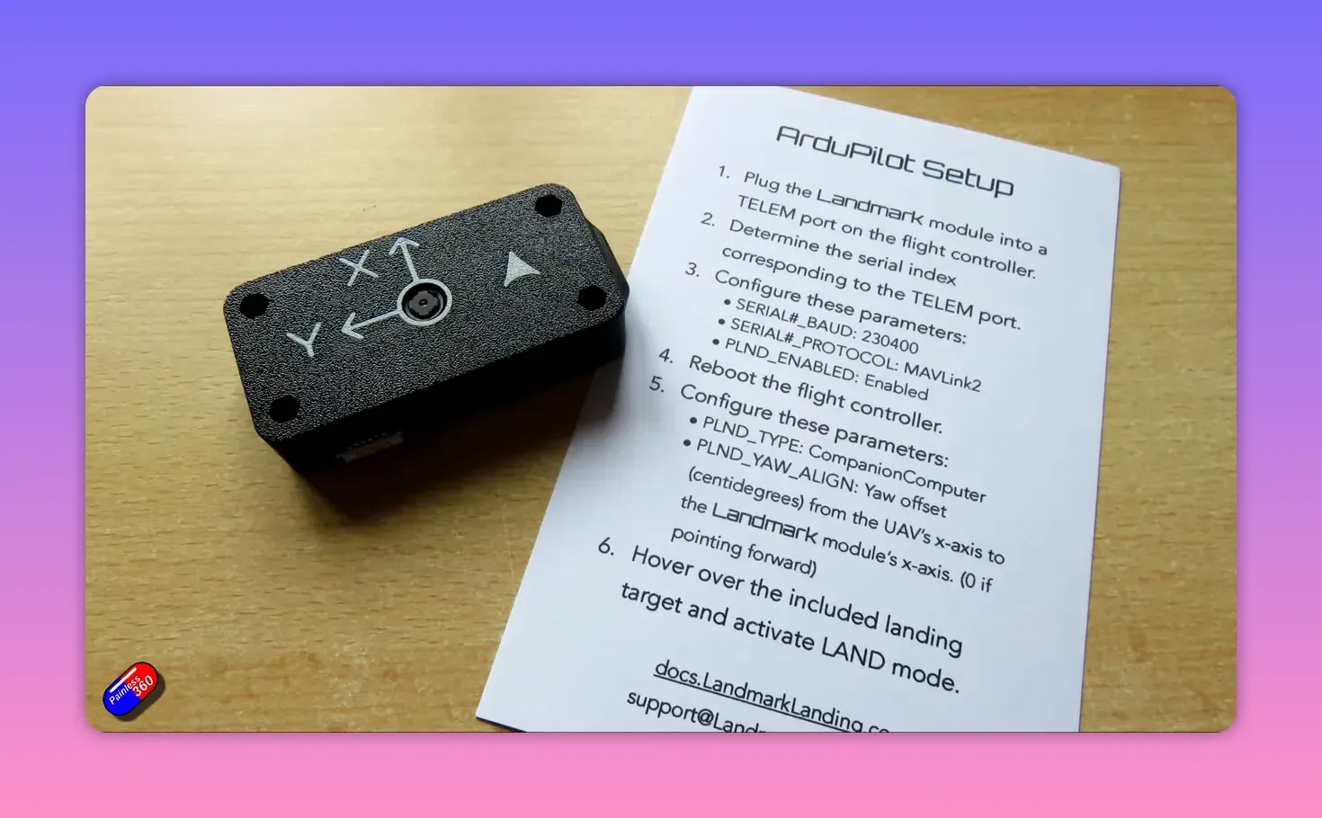 ArduPilot setup instructions on a printed sheet next to the Landmark precision-landing module showing baud, MAVLink2 and PLND parameters