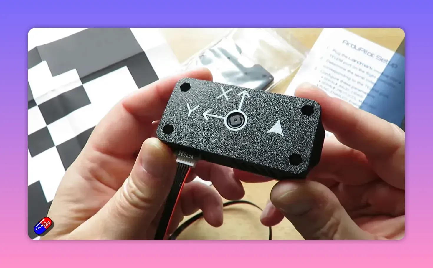 Close-up of Landmark precision-landing unit showing X and Y orientation arrows and the camera aperture