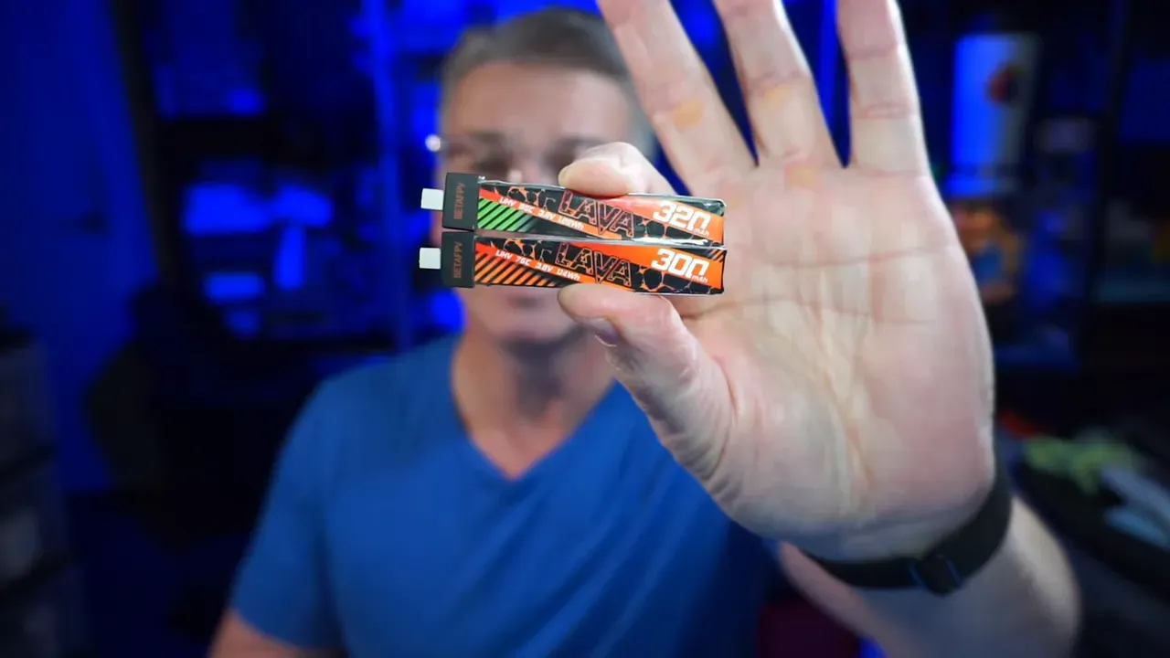 Two stacked Lava battery packs with the top pack labeled 320mAh and the bottom pack labeled 300mAh for comparison