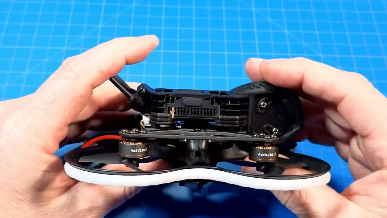 Side view of Pavo20 Pro II showing the daughter board and battery connector tucked between the camera mount and frame, illustrating a potential crush point