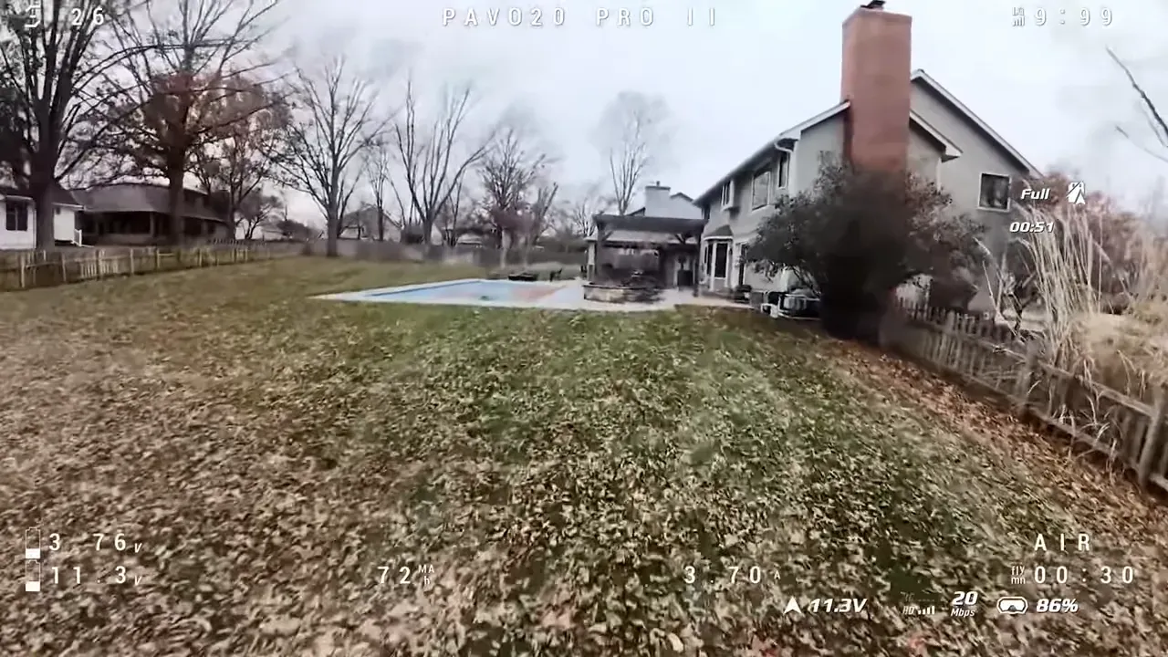 FPV view from Pavo20 Pro II flying over a backyard lawn with a level horizon and telemetry overlay, demonstrating stable footage
