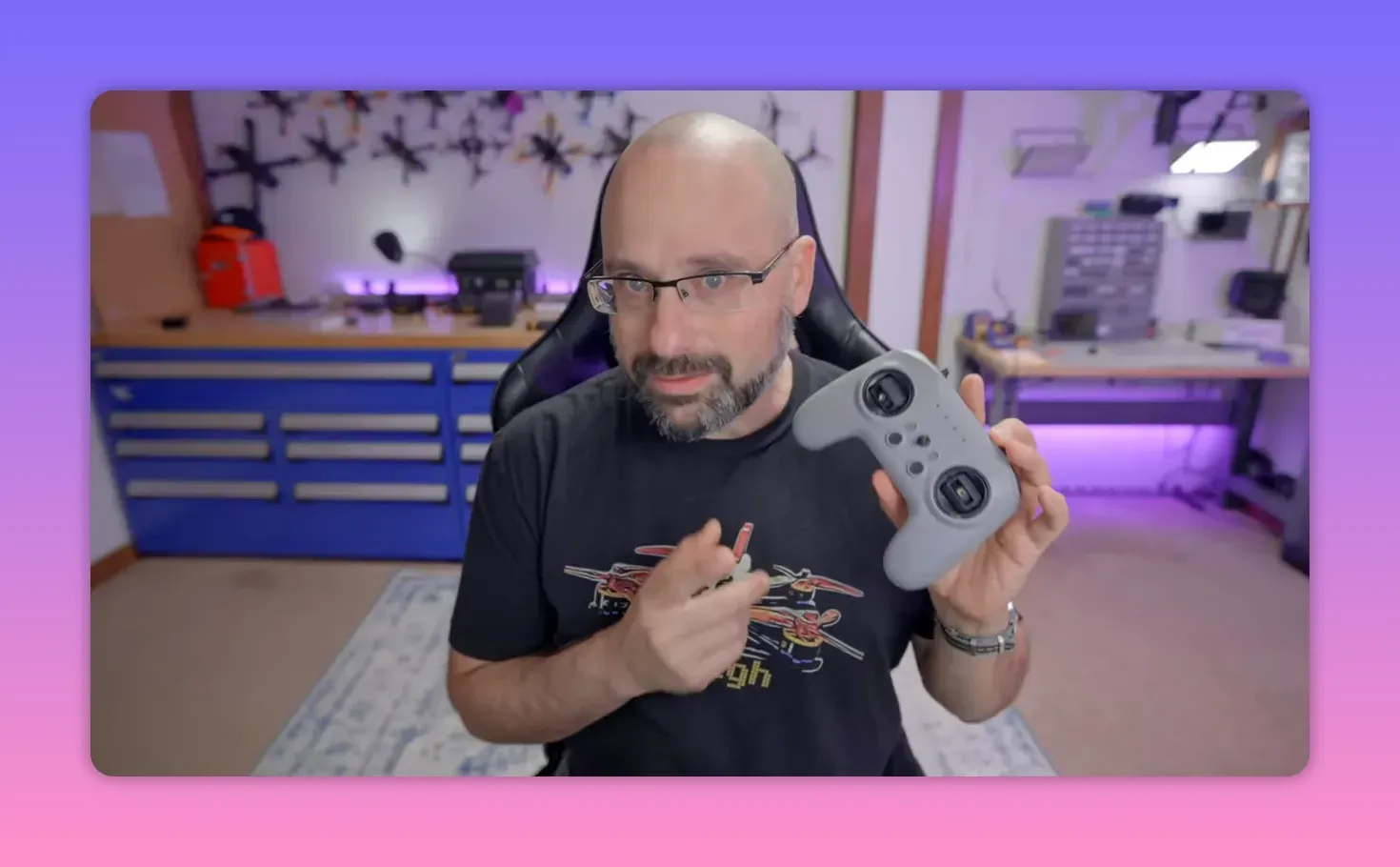 Grey T8L radio controller held up to camera showing gimbals, buttons, and layout