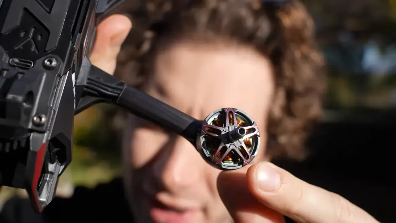 Front-facing close-up of NBlade MAX motor mounted to the arm with blurred reviewer behind