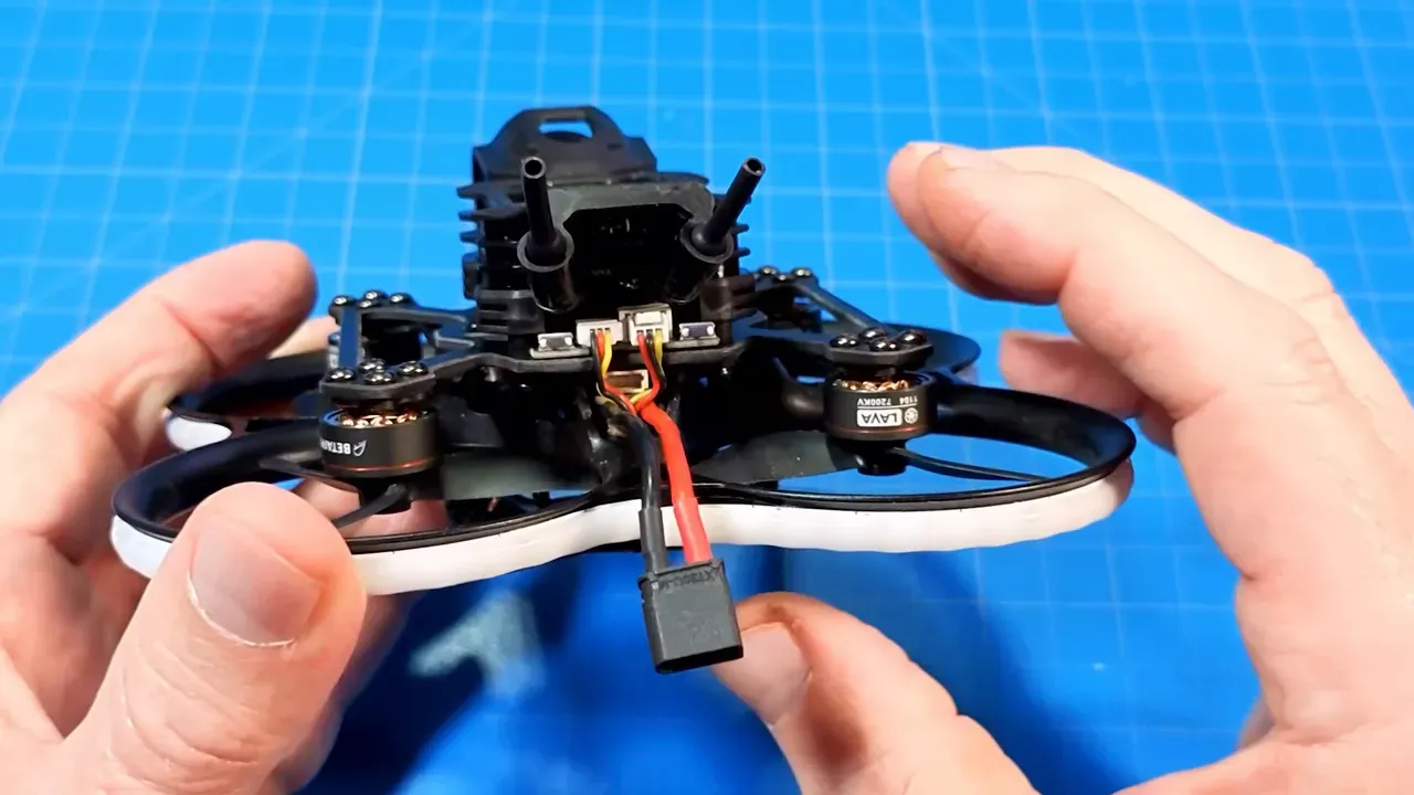 Rear view of Pavo20 Pro II showing daughter board connectors and wires partially covering the USB port with XT30 battery plug visible