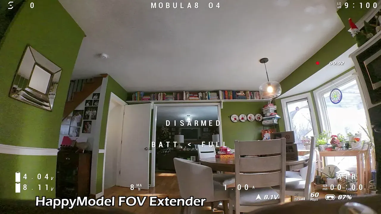 Wide DVR frame of a dining room flight labeled 'HappyModel FOV Extender' showing expanded field of view, clear room details and flight telemetry