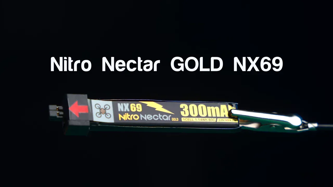 Centered Nitro Nectar GOLD NX69 300mAh battery held by a clip against a black background with bold product title above; crisp, high‑contrast studio shot.