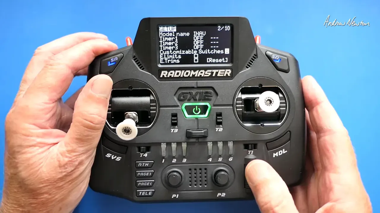 Radiomaster GX12 transmitter close-up displaying the SETUP menu with 'Customizable Switches' option, hands holding the radio.