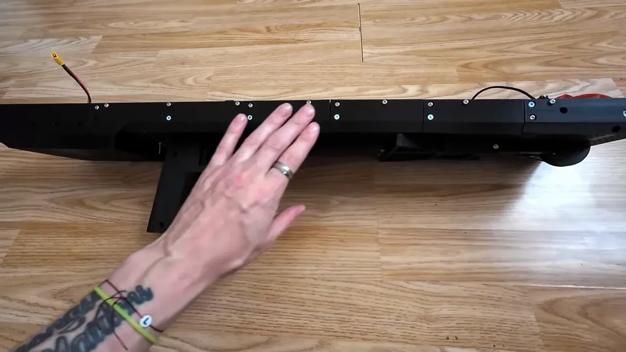 Clear top view of Drone Slinger V2 modular printed frame showing bolts, seams and rail texture