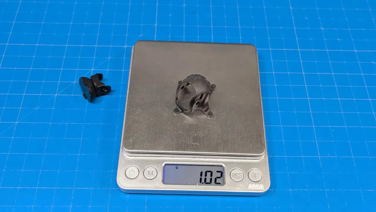 HappyModel canopy and small extender parts on a digital scale showing 1.02 grams