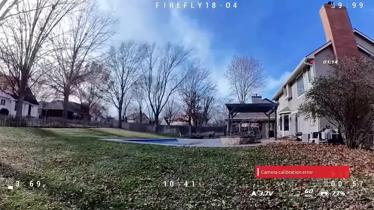 Wider DVR frame of a backyard and pool area showing expanded field of view, clear sky and a red 'Camera calibration error' overlay