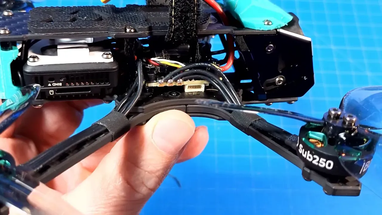 OasisFly35 tail stack and wiring close-up showing flight controller area, receiver placement, and motor wiring