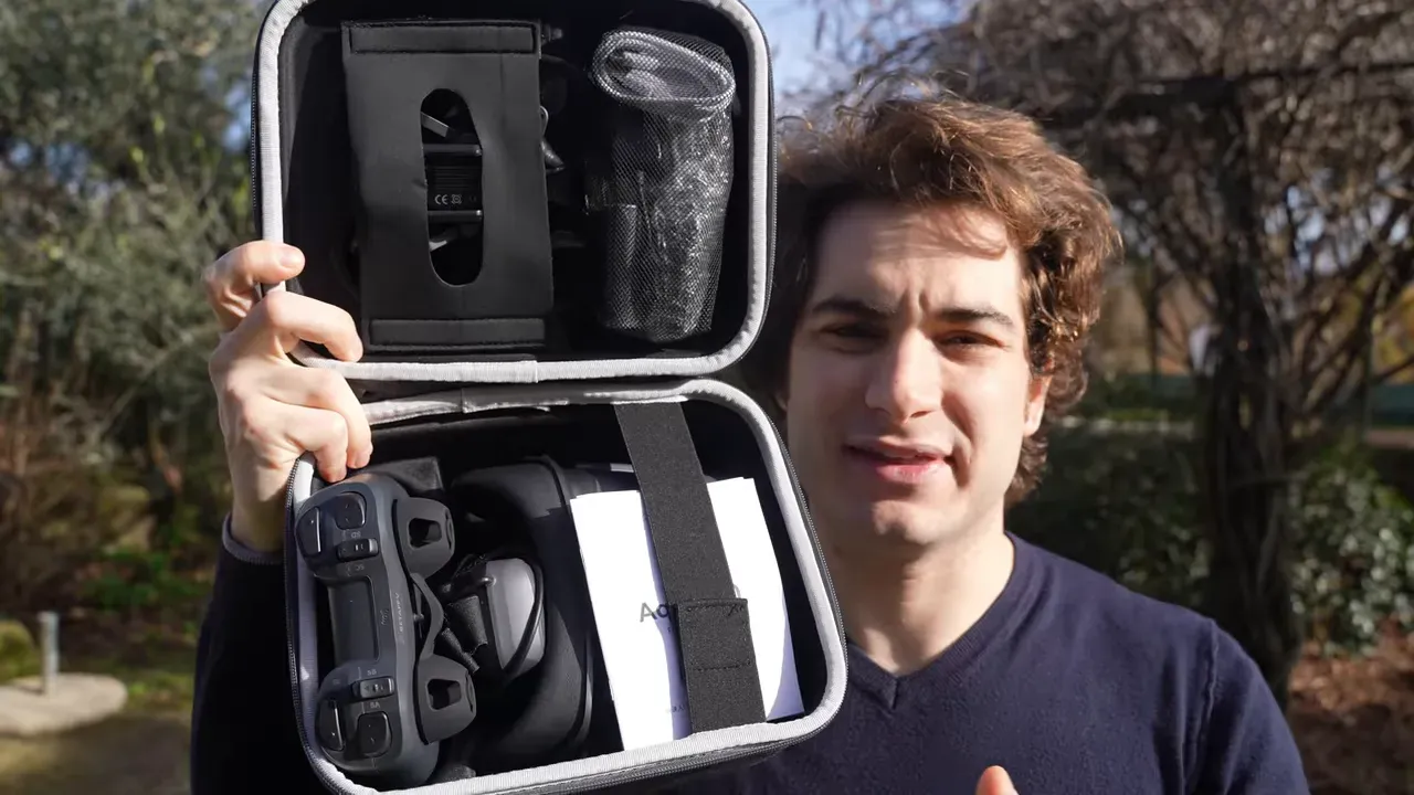 Open Aquila20 HD carry case showing VR04-style goggles, Light Radio controller and manual with presenter visible behind