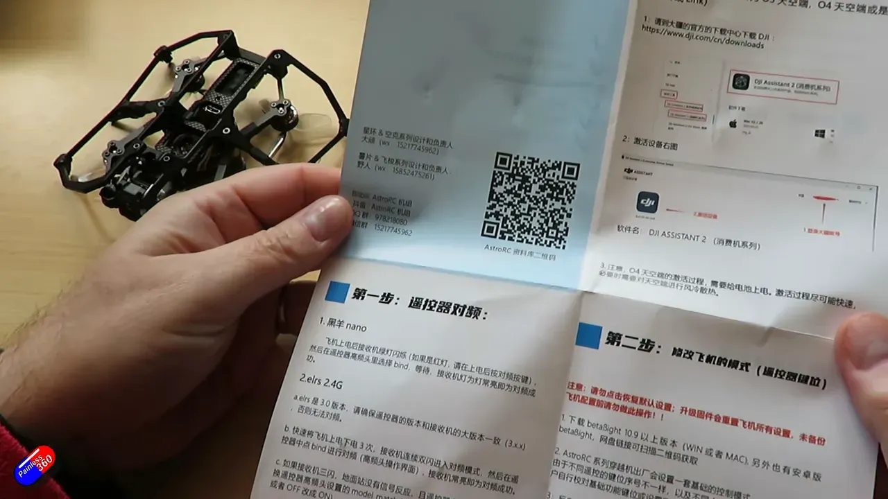 Open manual showing ExpressLRS (elrs 2.4G) binding instructions and QR code with Carbonfly 80 on the side