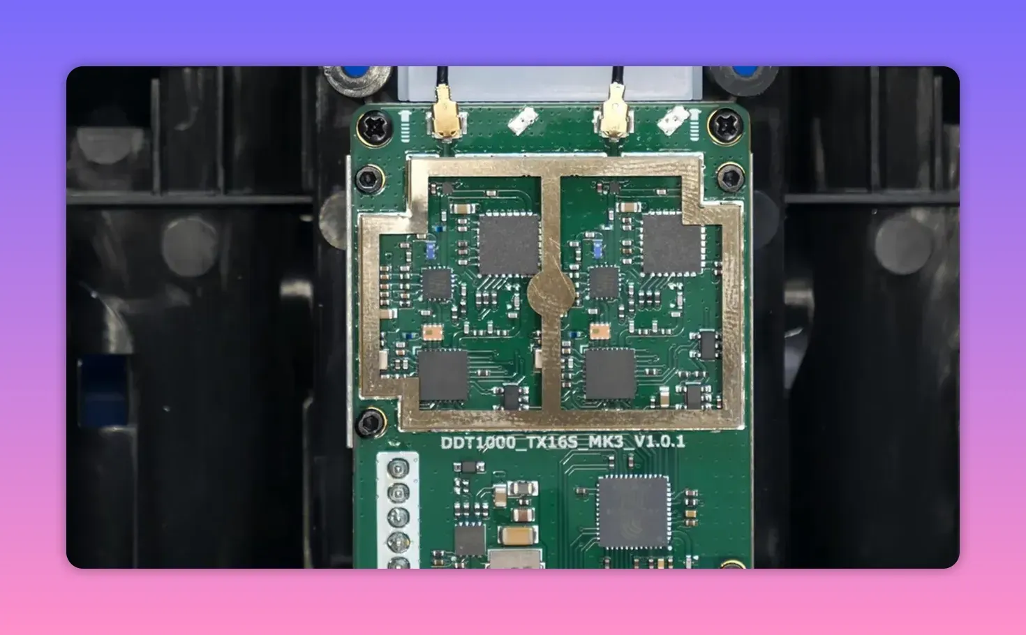Close-up photograph of the TX16S MK3 RF module PCB showing two radio transceiver chips and coax antenna connectors