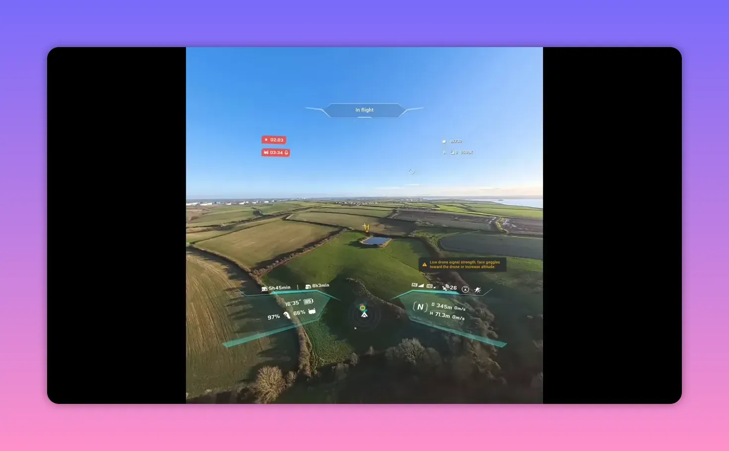 Clear FPV goggles view showing horizon, 'In flight' HUD, telemetry and a prominent low drone signal warning over fields