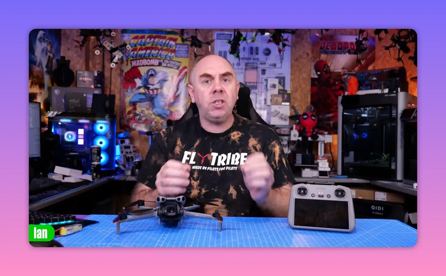 Centered view of presenter with DJI Mini-series drone and controller clearly visible on a blue work mat