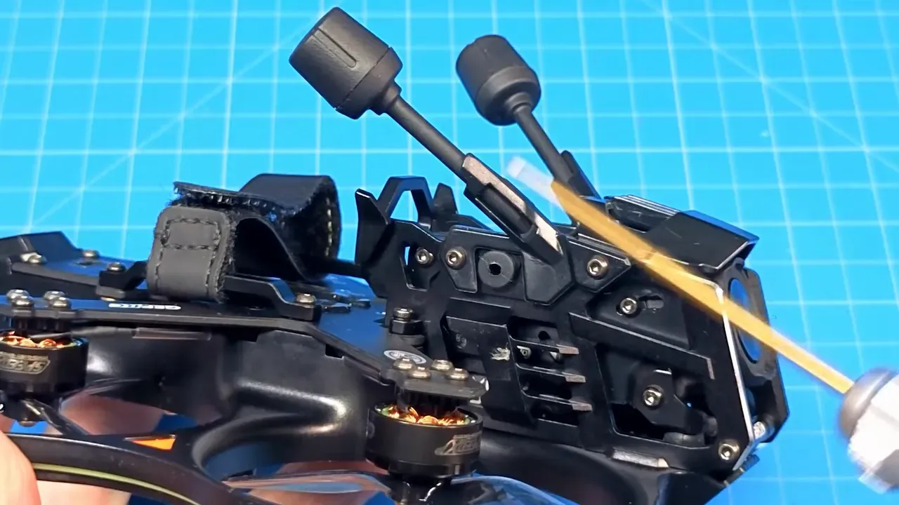 Cinebot25 V2 rear module close-up with supplied antennas, camera cage and mounting strap