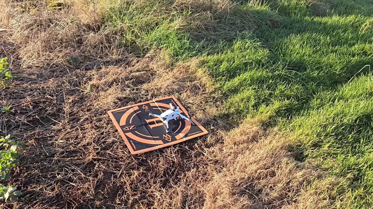 Anti-Gravity A1 drone on an orange landing pad in grass