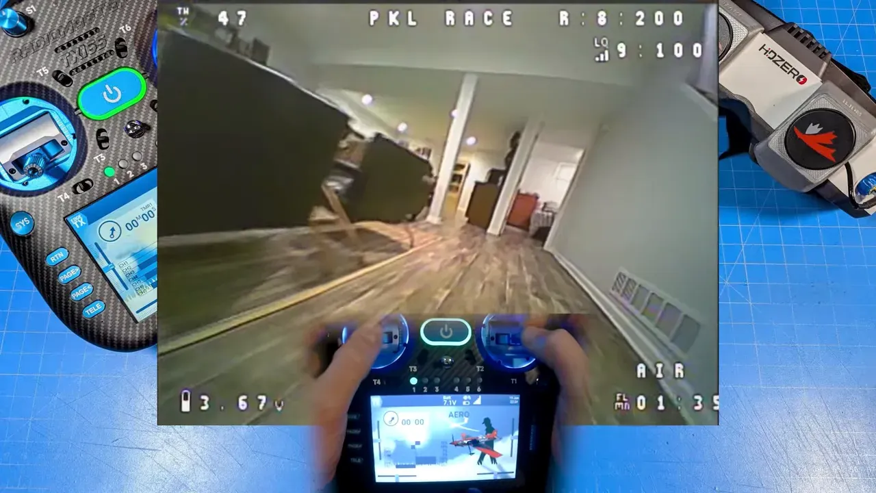 RadioMaster TX16S Mk3 Max centered on blue work mat showing 480×800 touchscreen, hands on gimbals and FPV overlay (corridor view)