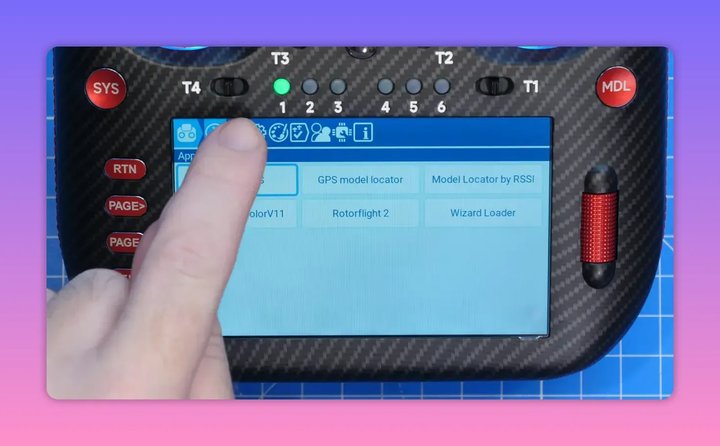 Finger tapping the TX16S MK3 5-inch touchscreen to access EdgeTX app icons and menus.
