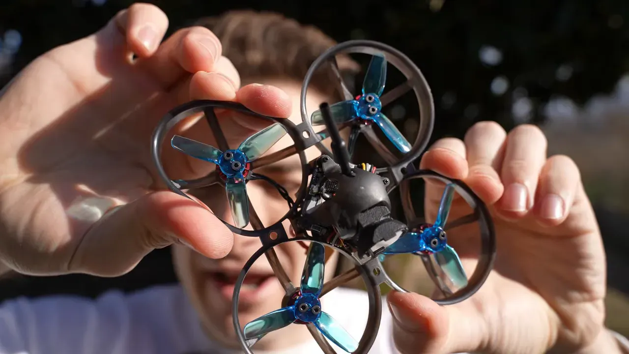 Mobula 8 close-up showing O4 Lite camera, swiveling mount, antenna and prop guards