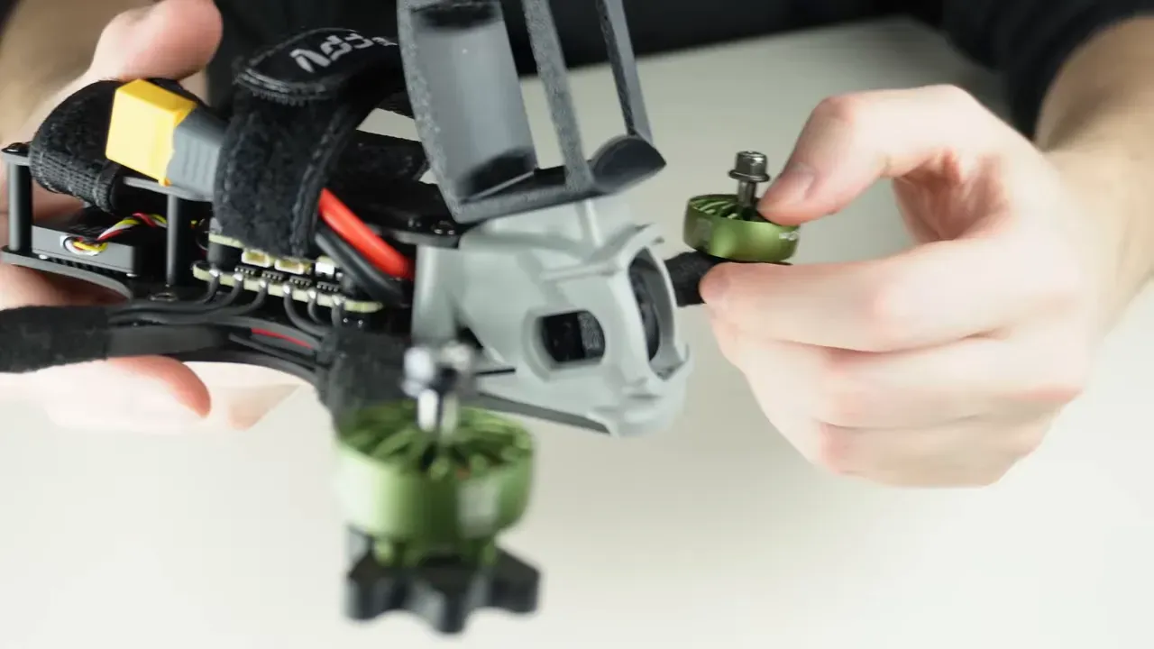 Top-front view of FPV quad showing antennas, camera and battery straps