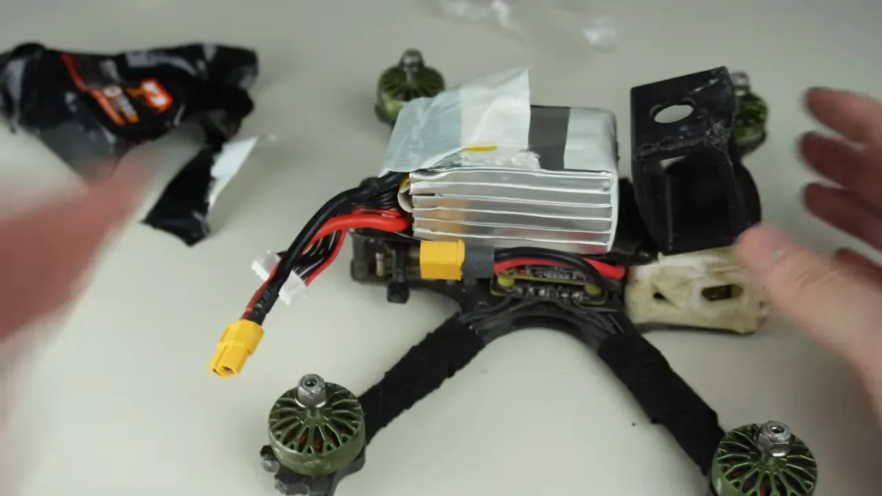 Mounted LiPo pack on a quad frame showing clearance and XT60 plug hanging out