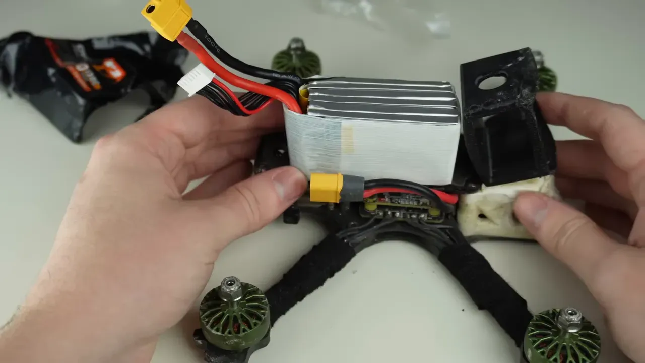 Freestyle FPV quad with battery mounted and no TPU guards, showing side VTX mount and motors