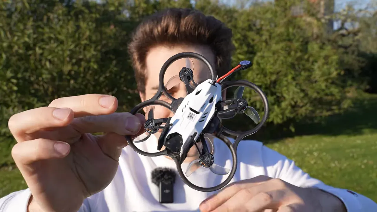 Oxbot Lumo18 tinywhoop held outdoors with DJI O4 Lite camera stack visible